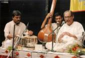 Panditji singing in a concert with Girish Nalavade on the tabla and Mukul Kulkarni providing vocal support